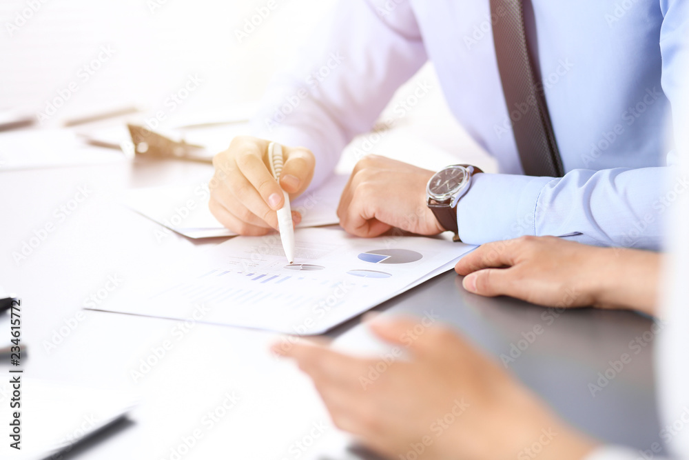 Group of business people working as a team at meeting. close-up. Colleagues or partners discussing financial results. Successful negotiation concept Group of business people working as a team at meeting. close-up. Colleagues or partners discussing financial results. Successful negotiation concept