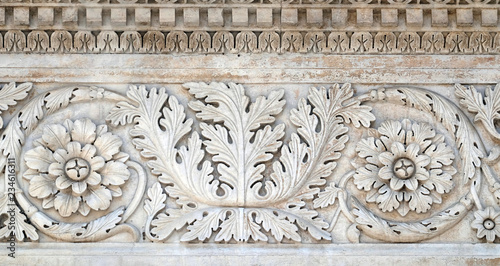 Stone carvings on the portal of Santa Maria Forisportam church in Lucca, Tuscany, Italy photo