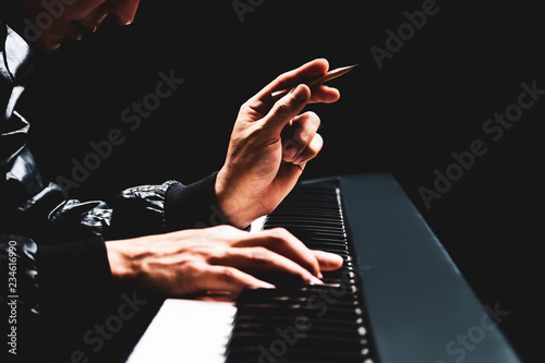 Konstfotografi male songwriter hands composing a song on piano, song writing concept