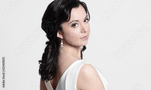 side view.young woman model in white dress