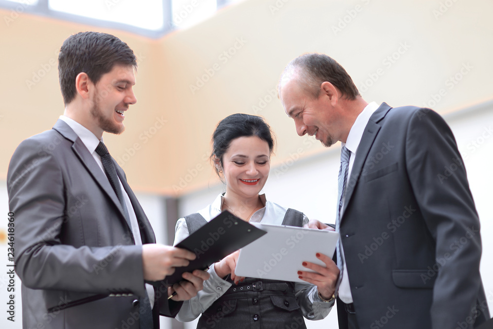 business team discussing work issues standing in the office business team discussing work issues standing in the office