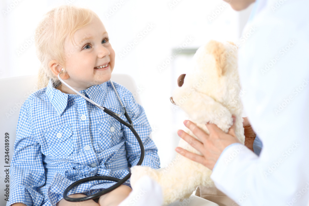 Doctor and a little blonde girl. Medicine and healthcare concept Doctor and a little blonde girl. Medicine and healthcare concept