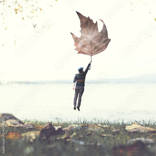man flying with a big leaf, surreal abstract concept