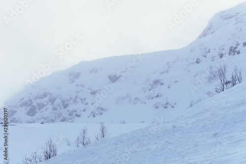 endless snow tundra and hills in northern Russia beyond the Arctic Circle on a winter frosty day