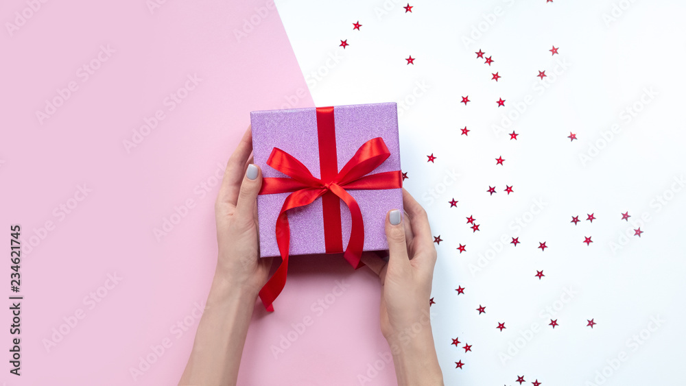 woman holding gift in hands. Pink gift box. Copy space. woman holding gift in hands. Pink gift box. Copy space.