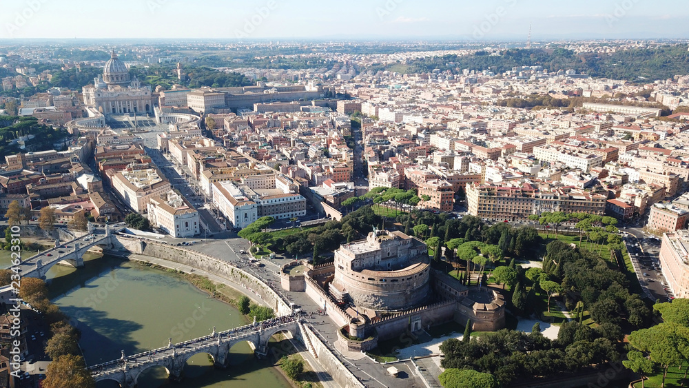 Fototapeta premium Aerial drone view of iconic Castel Sant'Angelo (castle of Holy Angel) and Ponte or bridge Sant'Angelo with statues in river of Tiber next to famous Vatican, Rome, Italy