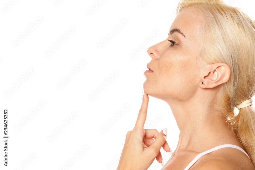 Portrait of beautiful blonde woman touching her chin on white background Portrait of beautiful blonde woman touching her chin on white background