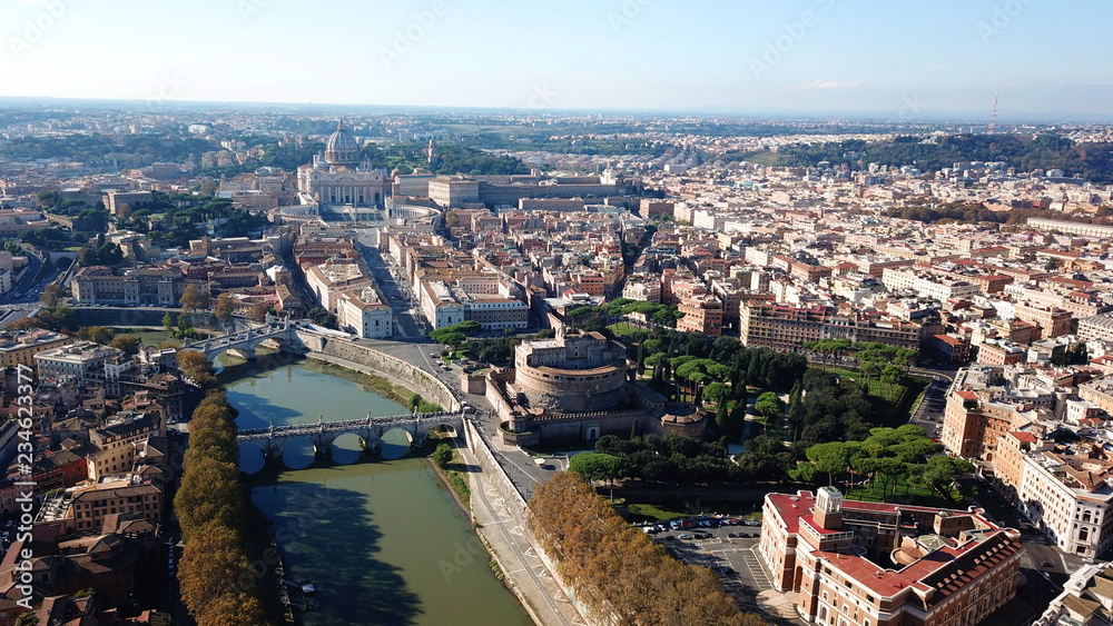 Aerial drone view of iconic Castel Sant'Angelo (castle of Holy Angel) and Ponte or bridge Sant'Angelo with statues in river of Tiber next to famous Vatican, Rome, Italy