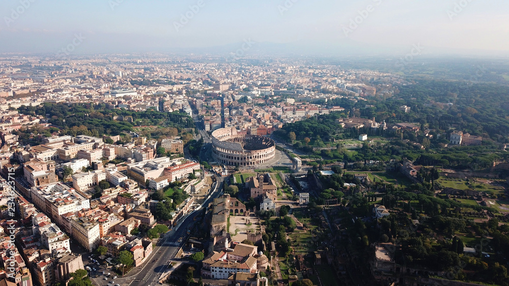 Aerial drone view of iconic and beautiful ancient Arena of Colosseum, also known as the Flavian amphitheatre in the heart of Roman Forum, rome, Italy