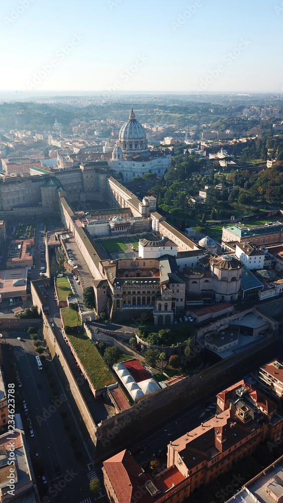 Fototapeta premium Aerial drone view of Saint Peter's square in front of world's largest church - Papal Basilica of St. Peter's, Vatican - an elliptical esplanade created in the mid seventeenth century, Rome, Italy