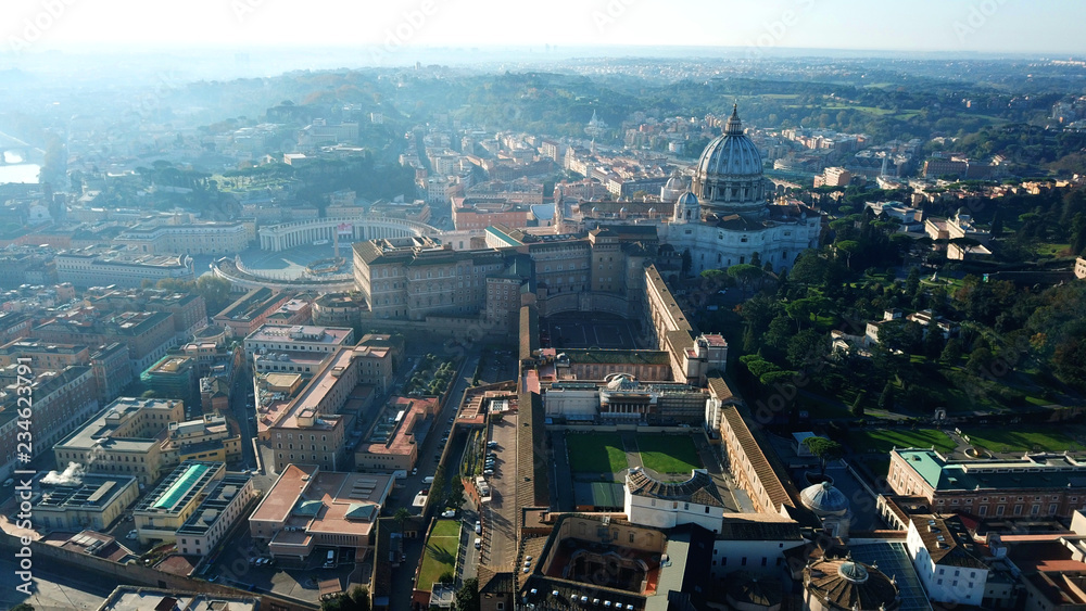 Fototapeta premium Aerial drone view of Saint Peter's square in front of world's largest church - Papal Basilica of St. Peter's, Vatican - an elliptical esplanade created in the mid seventeenth century, Rome, Italy