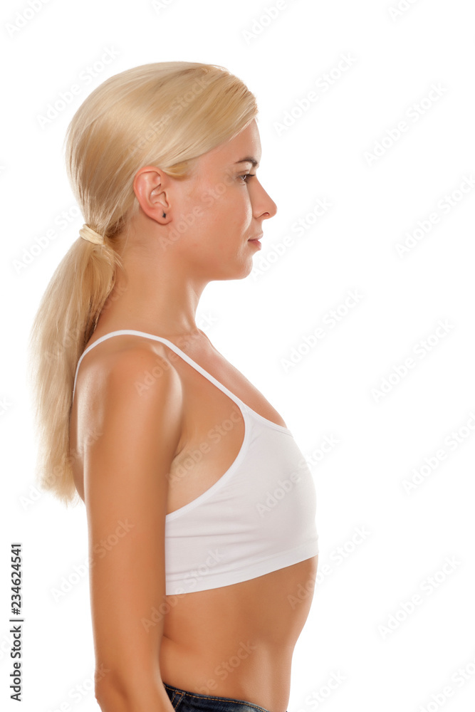 Profile of young blonde with small breasts on white background