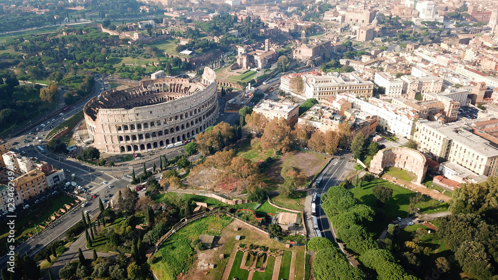 Obraz premium Aerial drone view of iconic ancient Arena of Colosseum, also known as the Flavian amphitheatre in the heart of Rome, Italy