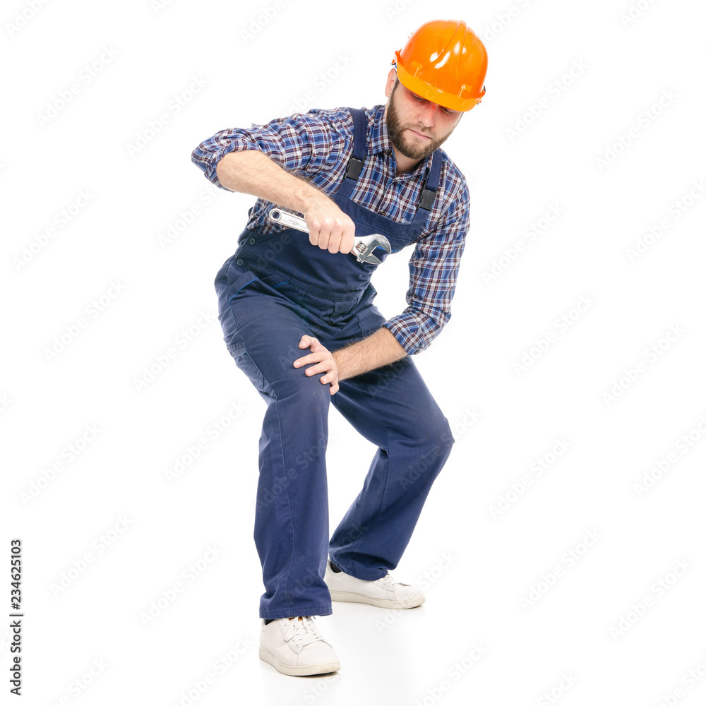 Young man builder industry worker hardhat with a adjustable wrench on white background isolation