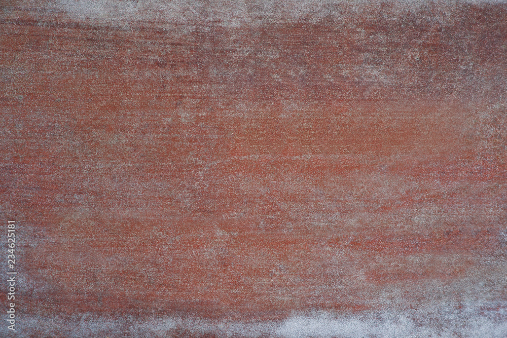 Texture of metal with touches of white paint. Textural background of painted metal with white strokes of paint. Design on a red-brown metallic background.