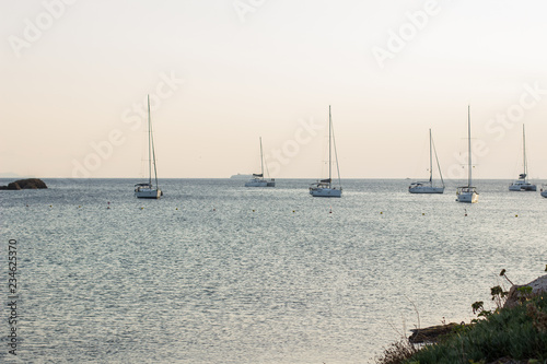 soft focus romantic landscape of sunset sea bay with yachts and boats