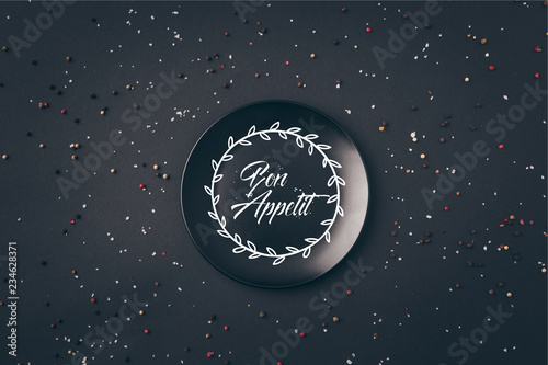 Cuadro en lienzo top view of black plate with bon appetit lettering on gray table