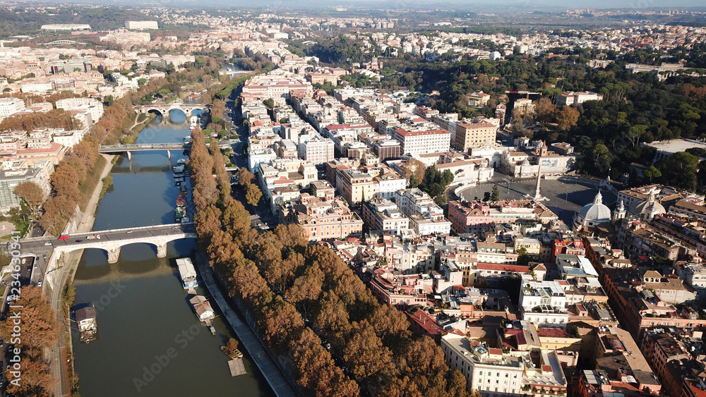 Aerial drone bird's eye view of iconic architecture in city of Rome next to river Tiber, Italy