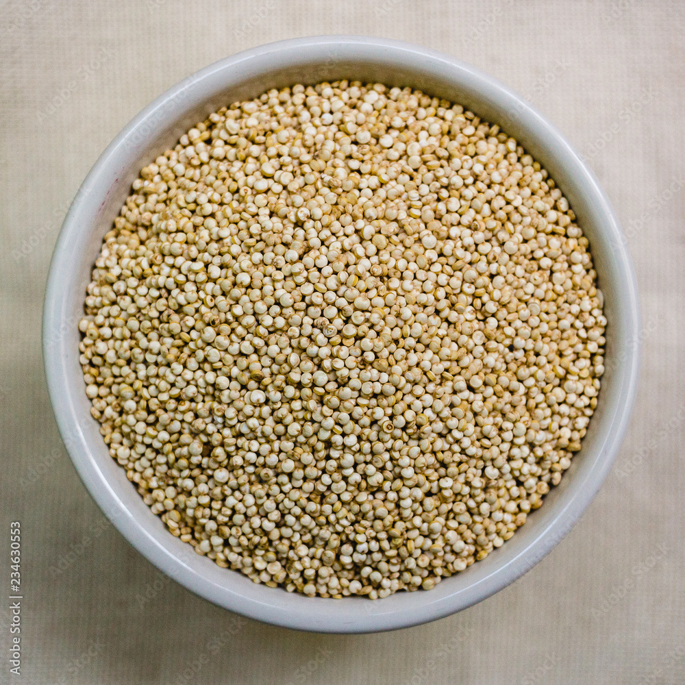 Quinoa in white cup. Raw white quinoa Quinoa in white cup. Raw white quinoa