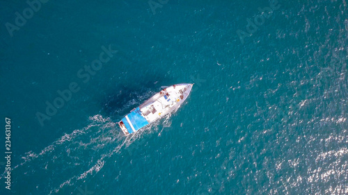 Aerial image of a small fishing boat roaring along The Mediterranean sea
