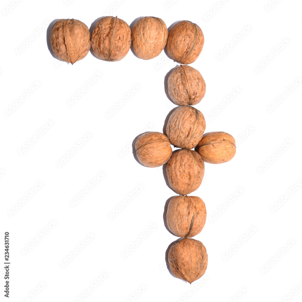 Number seven. Figure composed of nuts on a white isolated background. Number seven. Figure composed of nuts on a white isolated background.