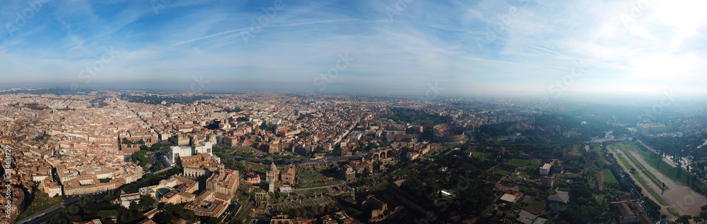 Aerial drone panoramic view from Roman Forum one of the main tourist attractions which was build in ancient times as the site of triumphal processions and elections next to Colosseum, Rome, Italy