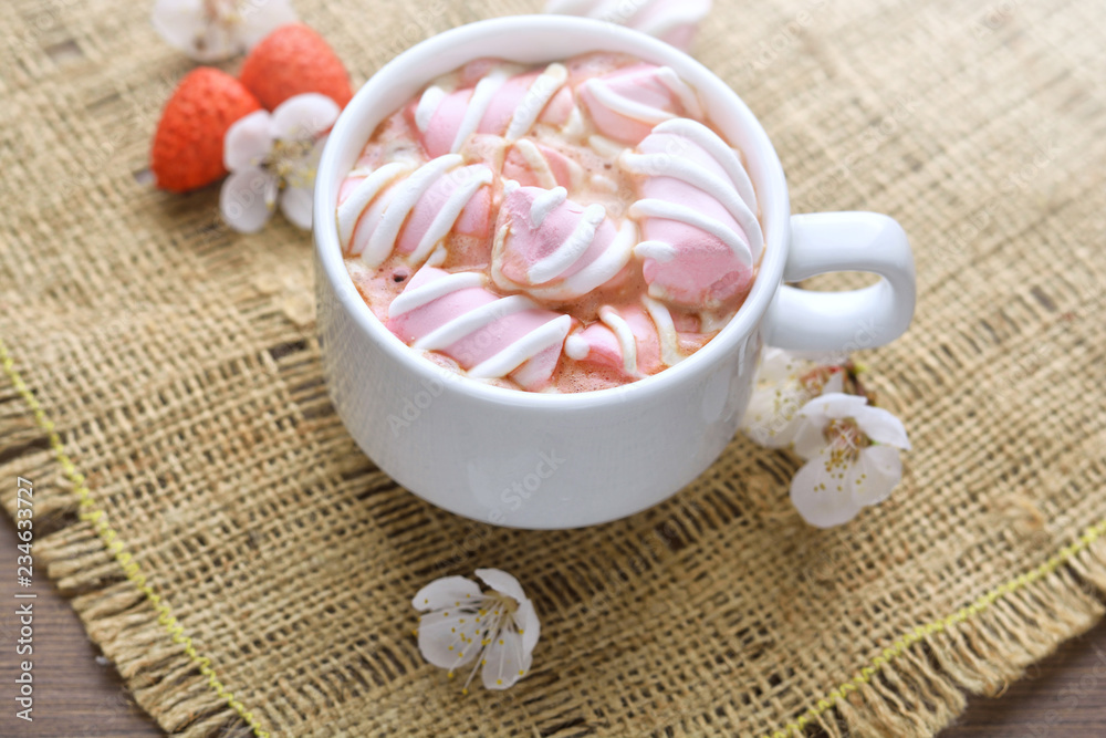 Mug of hot coffee with marshmallows on a wooden background Mug of hot coffee with marshmallows on a wooden background
