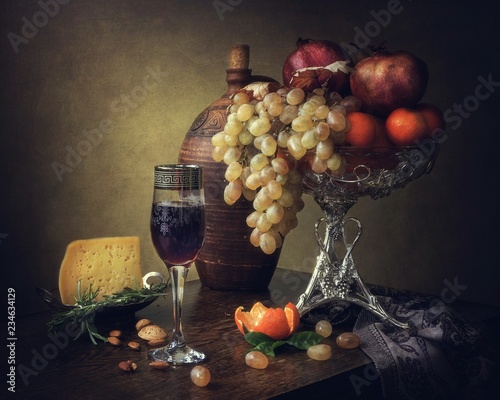 Still life with fruits and red wine glass