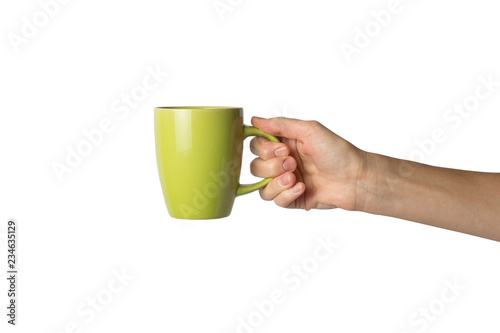 Female hand holding a green cup with hot coffee on a white background. Side view