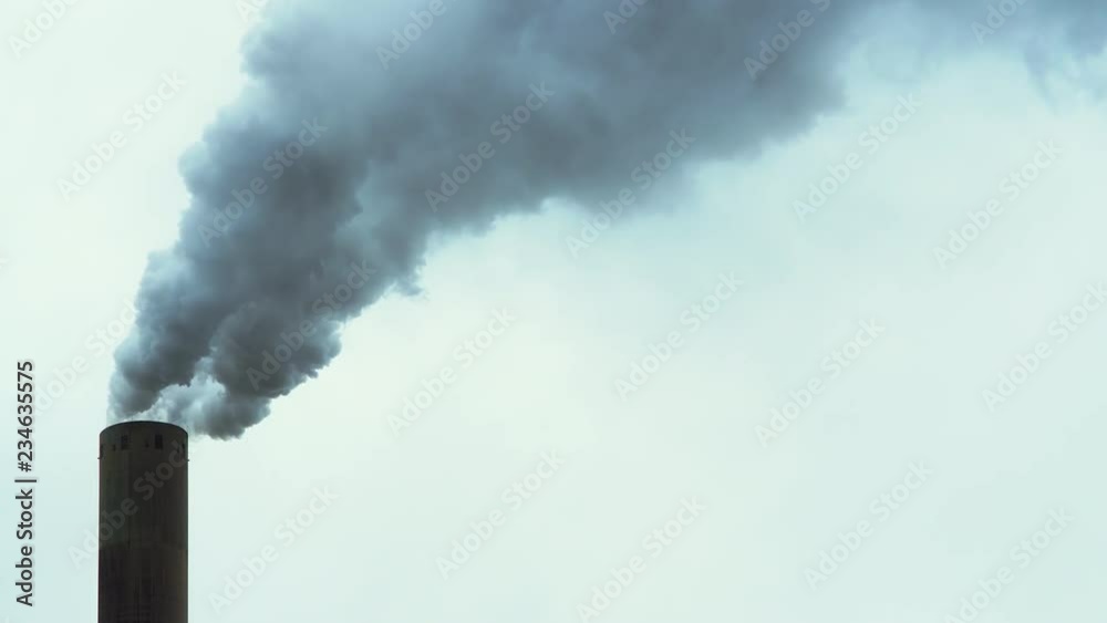 Chimney Of An Industrial Power Plant Blowing Out Smoke On A Rainy Day.