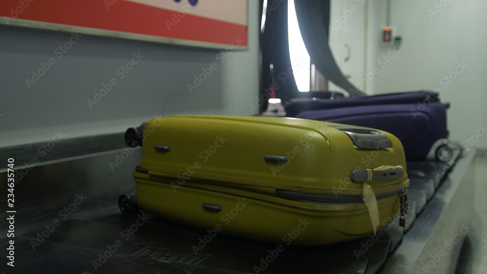 Airport baggage claim with luggage spinning around conveyor Airport baggage claim with luggage spinning around conveyor