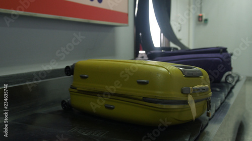 Airport baggage claim with luggage spinning around conveyor