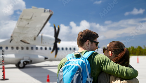 Fotografija travel, tourism and people concept - couple of tourists with backpacks over plan
