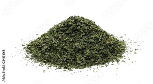 Chopped dry parsley leaves, pile isolated on white background