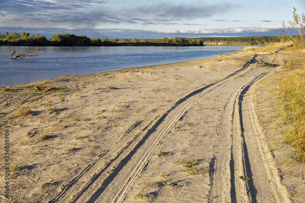 Sunset lighting of the autumn river bank in Siberia