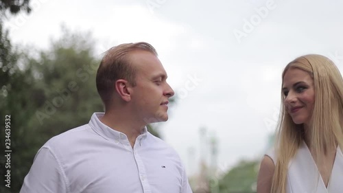 Attrective couple dance on the embanlment. Green background. Active pastime