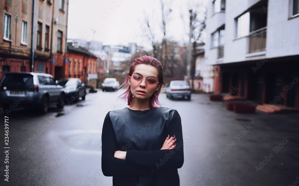 One girl stands on the center of road, outside spectacled One girl stands on the center of road, outside spectacled