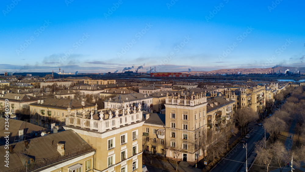 Aerial; drone panoramic view of Magnitogorsk cityscape with old buildings in empire style with decoration elements; beautiful development, architectural complex and parks; industrial background