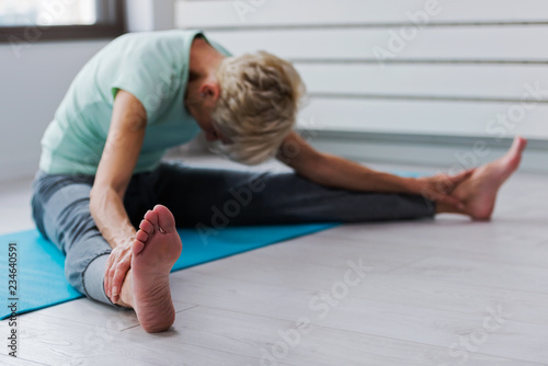 Active senior woman practicing yoga indoors. Exercise for Older Adults