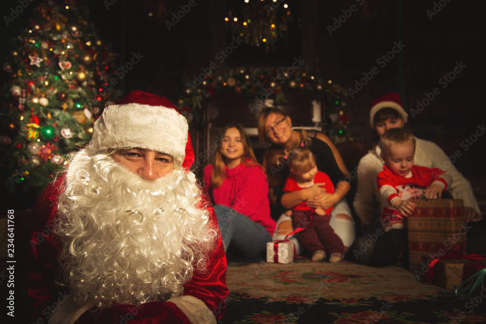 Christmas family portrait in a festive living room with a real Santa Claus. Christmas family portrait in a festive living room with a real Santa Claus.