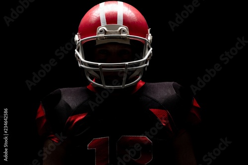 American football player standing with rugby helmet