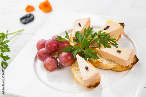 Fototapeta Naklejka Na Ścianę i Meble -  Terrine of delicious foie gras with fig jam on a white wood background