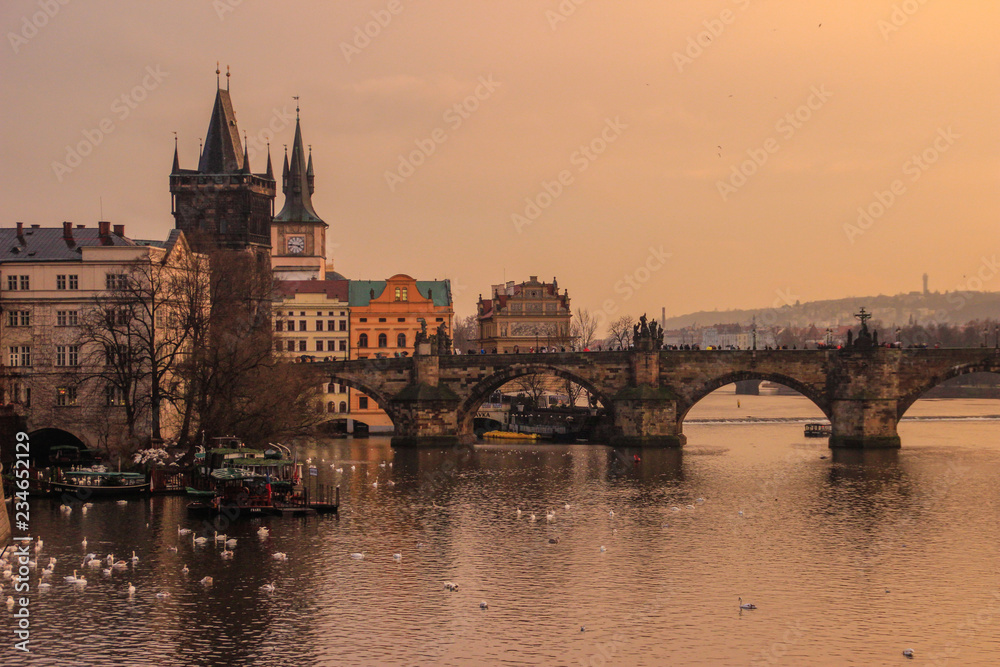 Yellow sunset over the Vltava River and the Charles Bridge in Prague, Czech Republic.