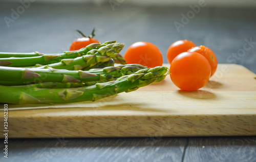 tomatoes and asparagus on the chopping board