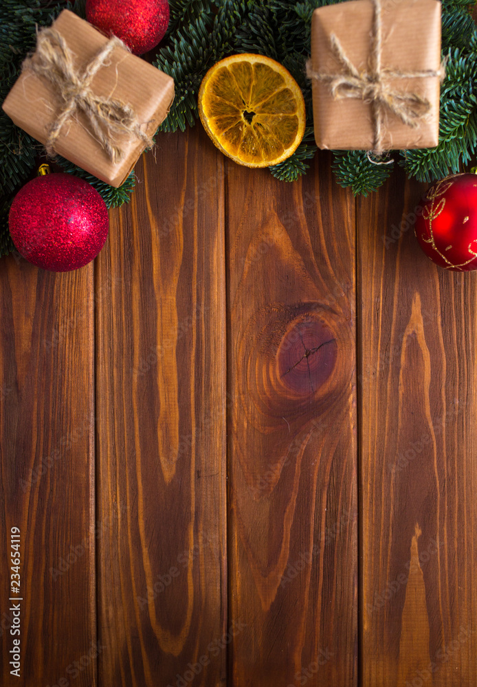 New Year's table with tangerines or oranges on a wooden table with branches of a Christmas tree and New Year's gifts.
New Year's table with tangerines or oranges on a wooden table with branches of a Christmas tree and New Year's gifts.