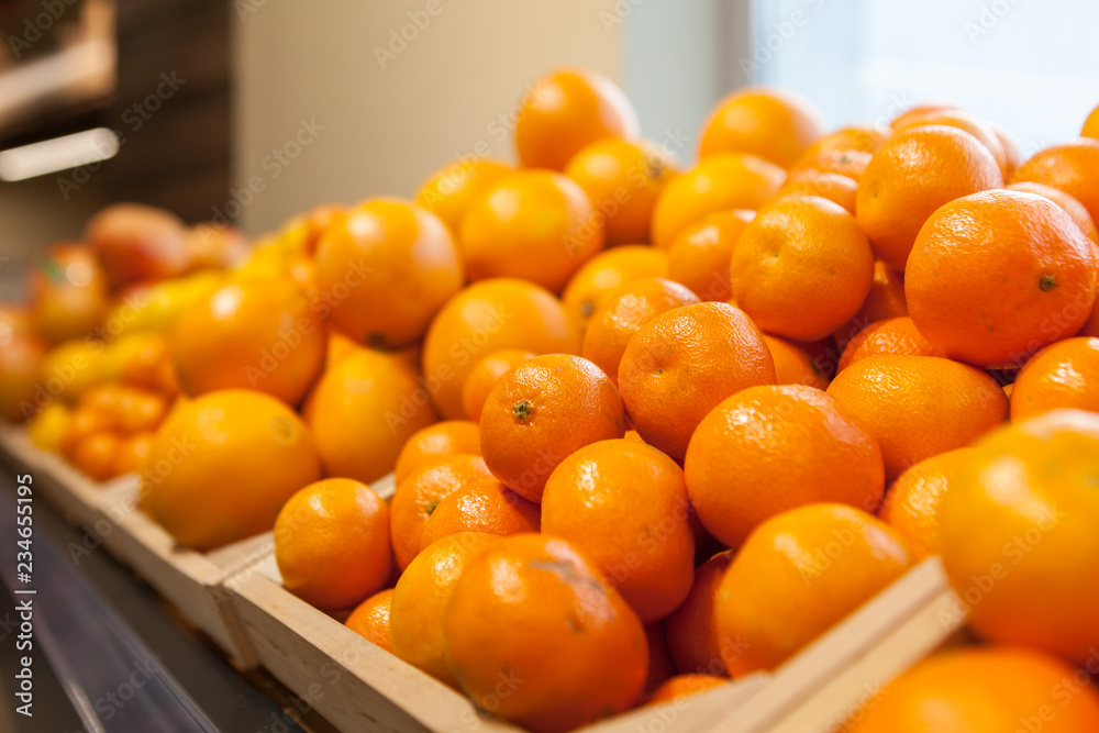 Tangerines and oranges at a showcase in a supermarket