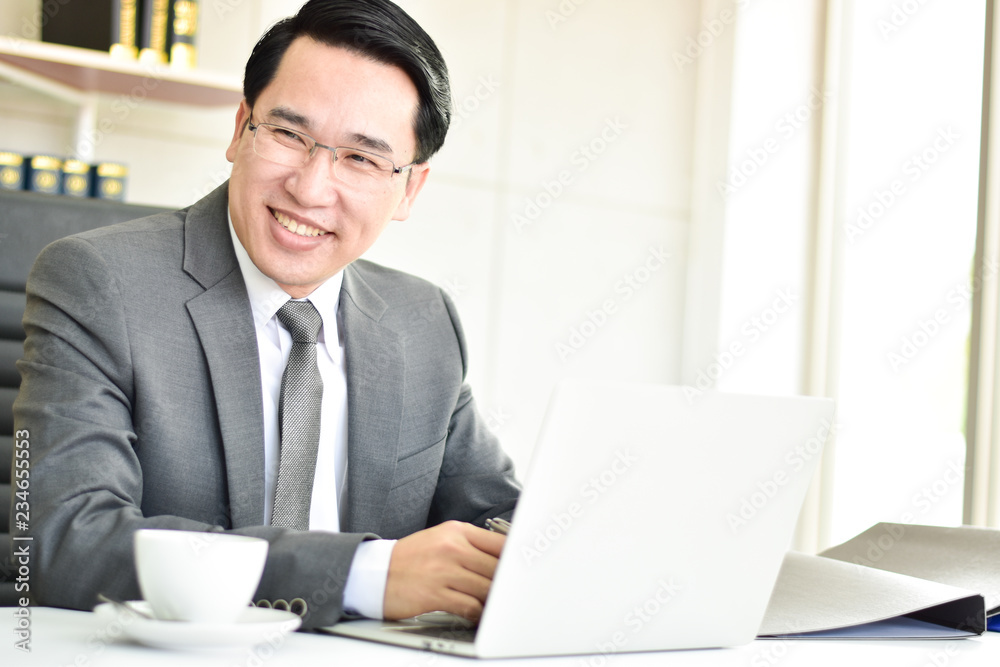 Businessman smiles at his colleagues with love. Warmth, friendliness The room has a computer. Delicious coffee Businessman smiles at his colleagues with love. Warmth, friendliness The room has a computer. Delicious coffee