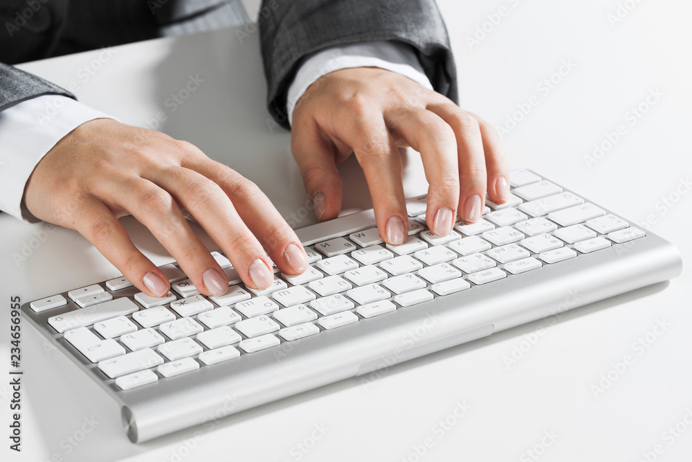 Closeup of businesswoman hand typing on keyboard with mouse on wood table Closeup of businesswoman hand typing on keyboard with mouse on wood table