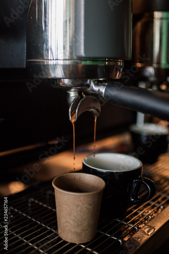 Espresso Coffee running into 2 cups of Flat White or Cappuccino Coffee's, from La Marzocco Coffee Machine.  photo
