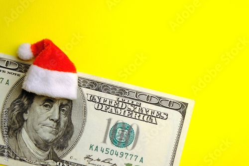 The image of Santa Claus Franklin on the hundred dollar bill USA. The concept of financial expenses for Christmas. Consumption or profit, debt or costs of Americans for the New Year. Copy space.